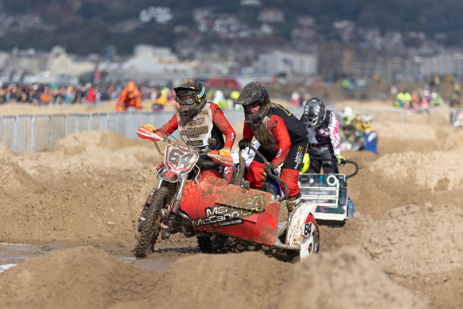 A motorbike and sidecar rider in action at the Weston Beach Race