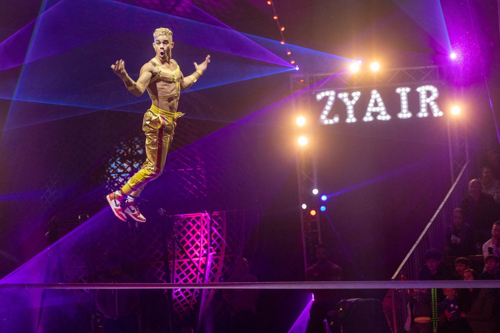 Circus performer jumps above the high wire
