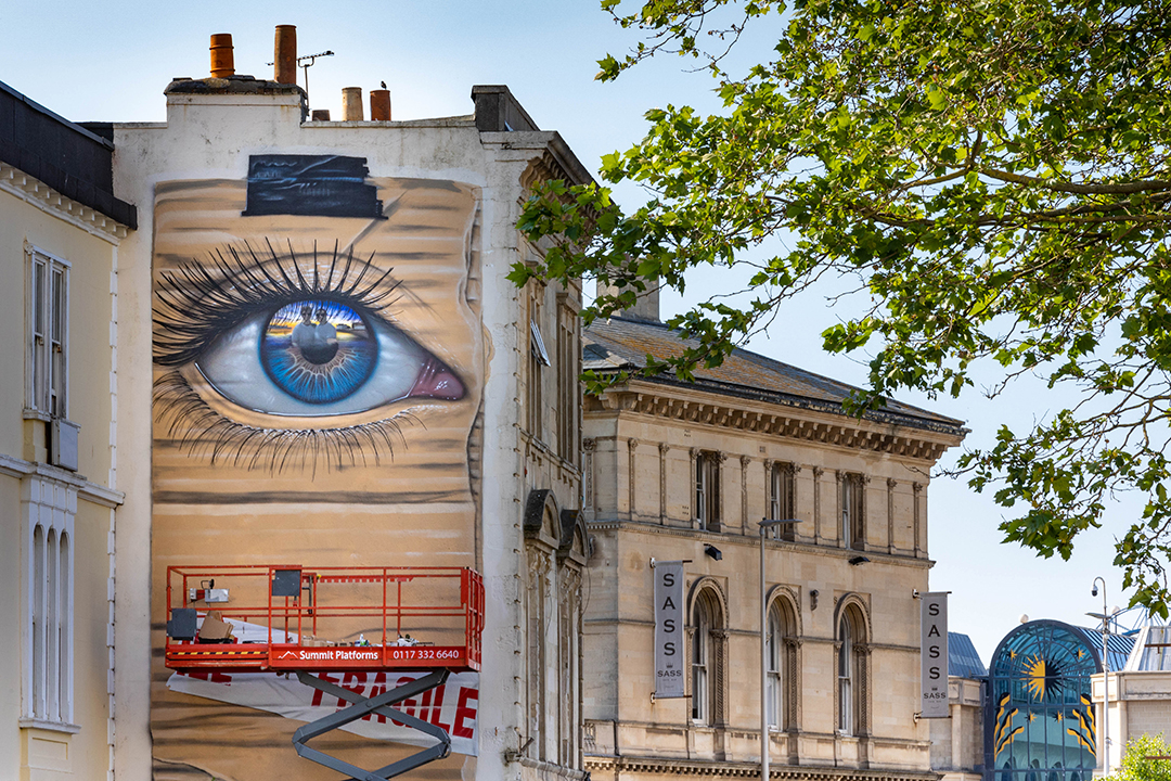 Mural of a giant eye with people inside it