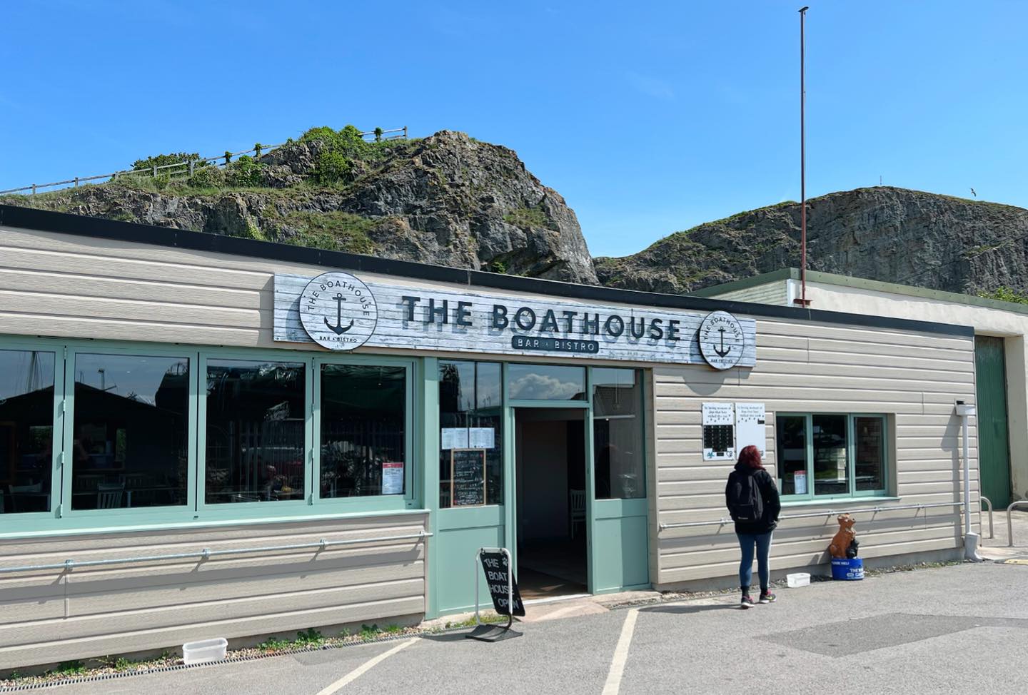 Photograph of Boathouse in Uphill with blue sky.