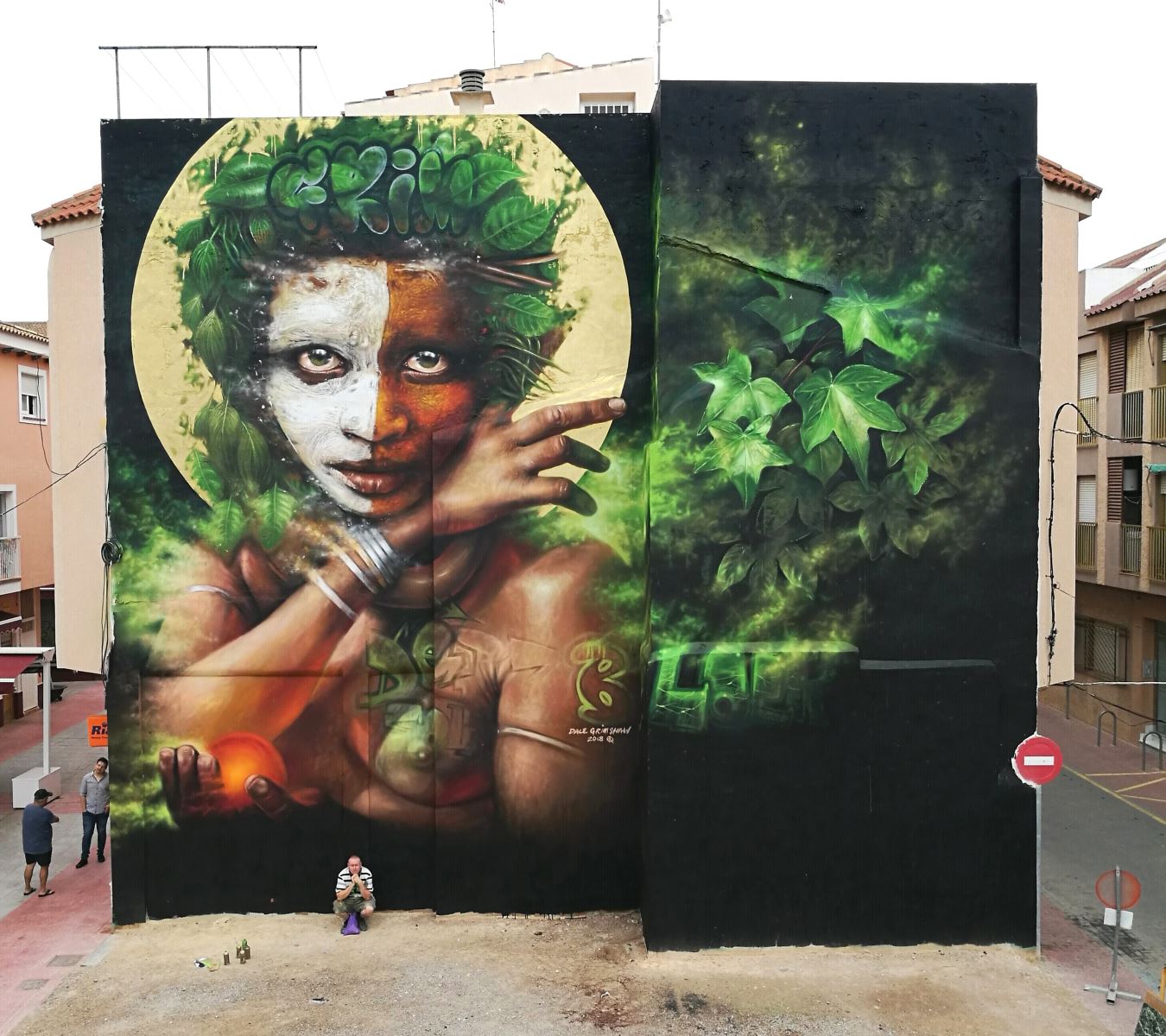 A huge wall in Spain featuring a half-white half brown face created by street artist Dale Grimshaw